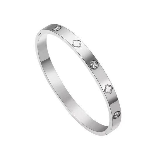 Silver bracelet with clover and gemstone accents on a white background
